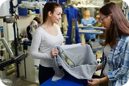 Two women discussing laundry business